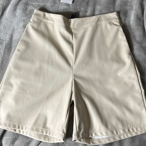 Faux leather cream shorts.
